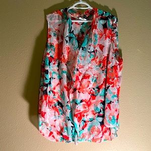 Light weight tank top with ruffle down the front.